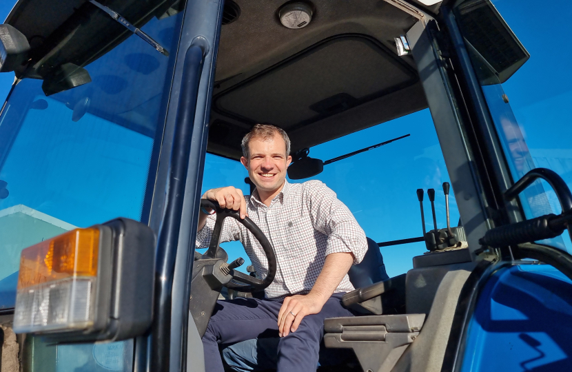 Andrew sitting in a tractor.