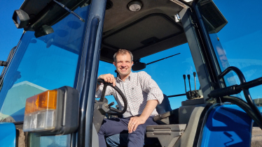 Andrew sitting in a tractor.