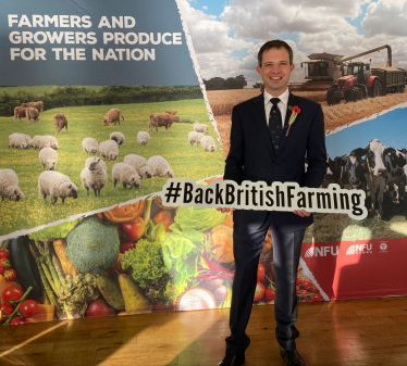 Andrew holding a Back British Farming sign